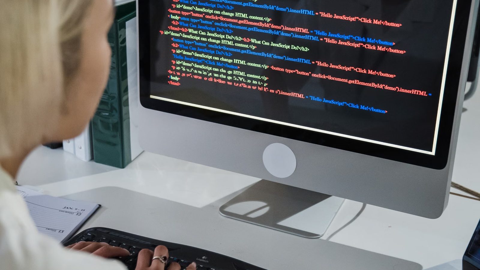 A developer at a monitor with website code
