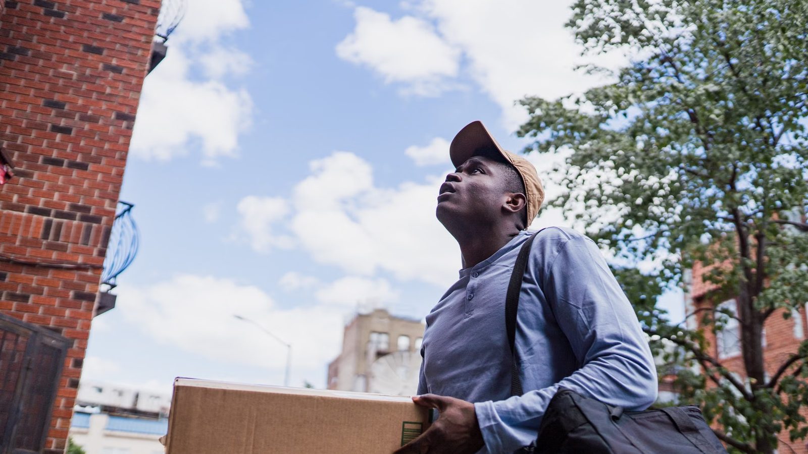 Courier carrying a parcel with an order