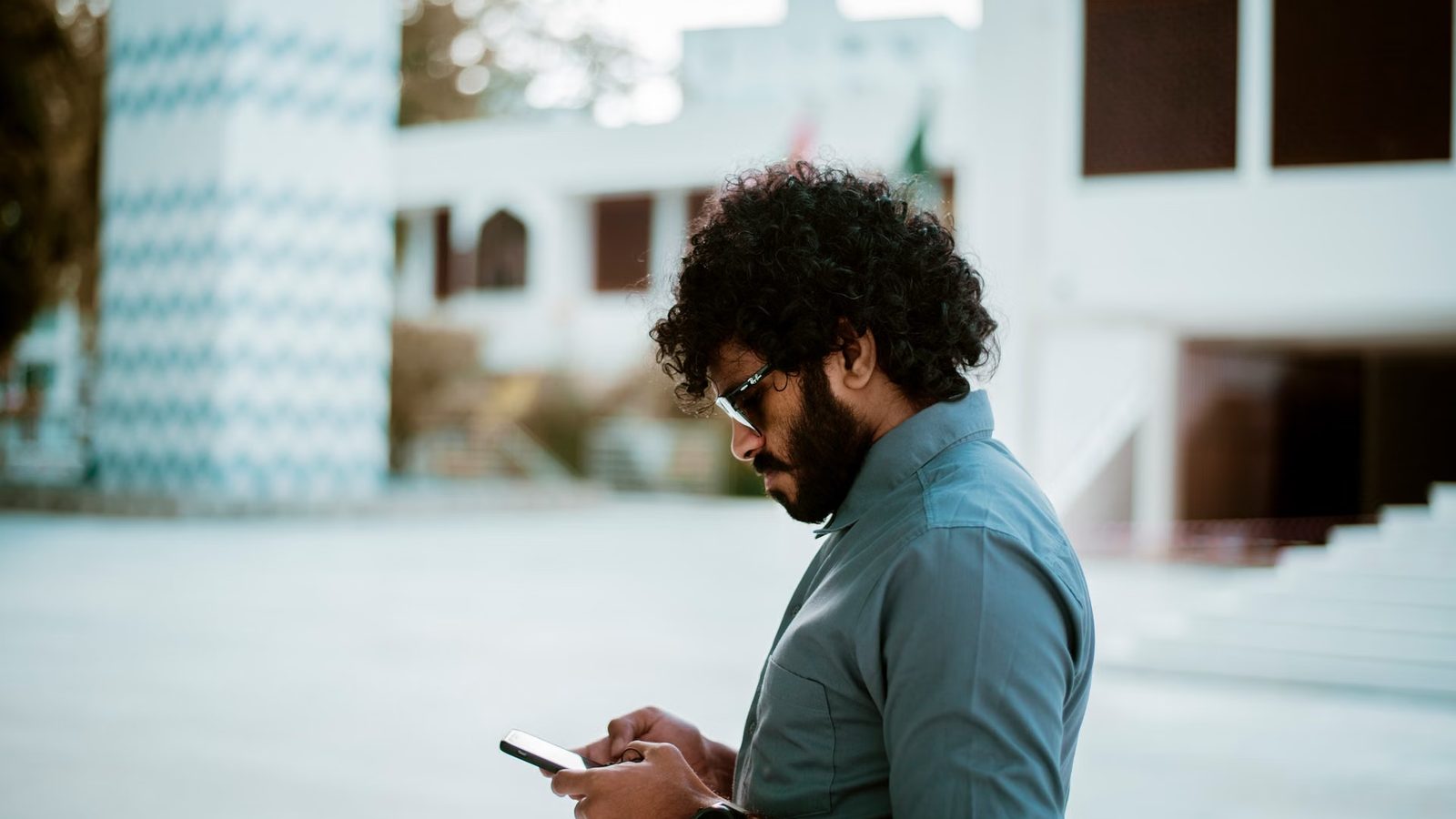 Man looking something up on his phone in the street