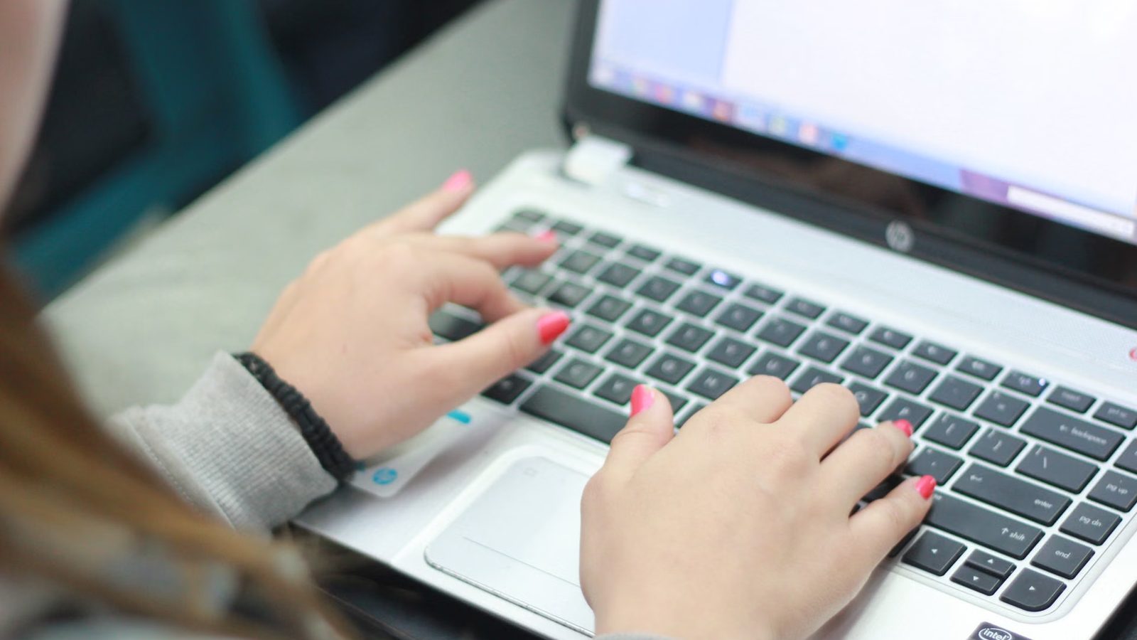 Hands on a laptop keyboard while working on a design