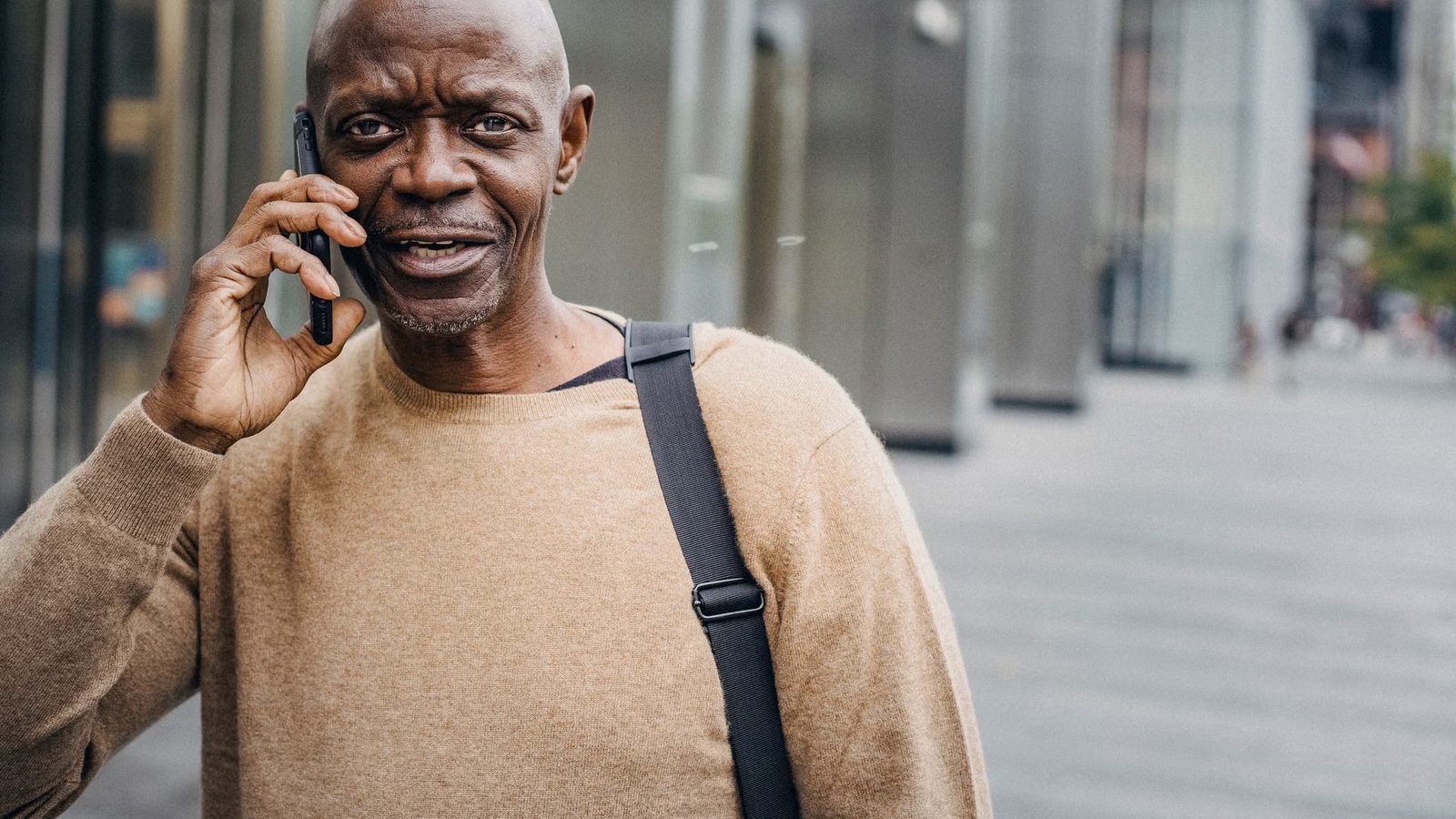A man talking on the phone in the street