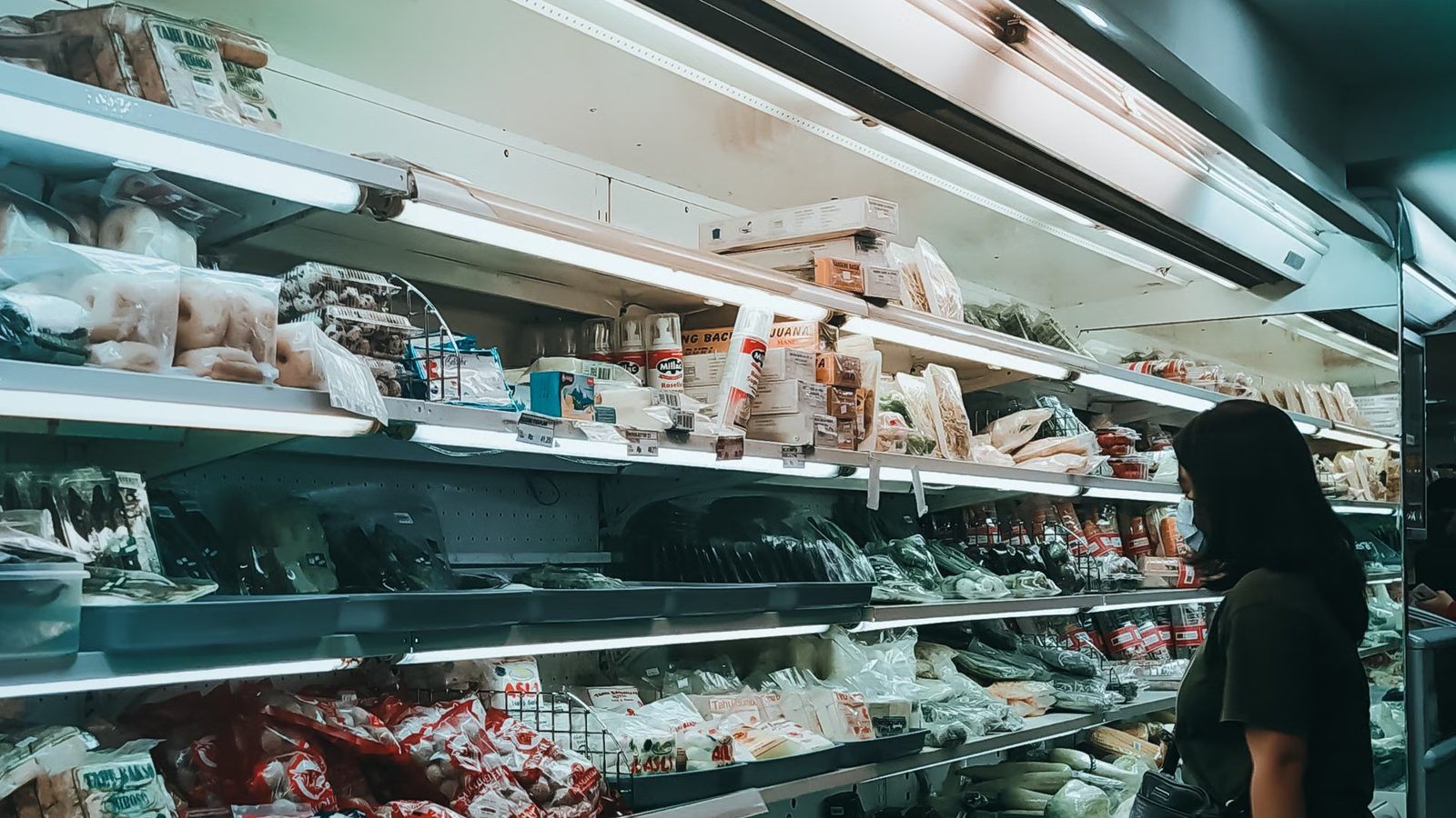 An aisle with goods neatly arranged on shelves